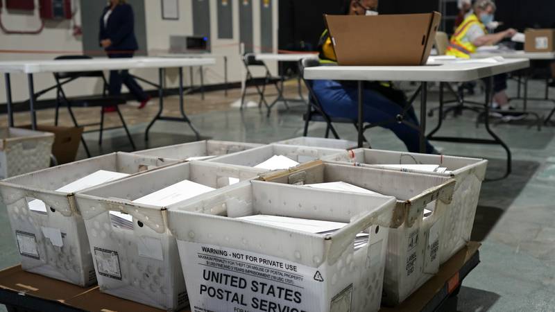 FILE - In this Sept. 3, 2020, file photo, workers prepare absentee ballots for mailing at the...