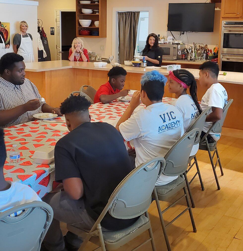 Students of the VIC Academy take a cooking class.