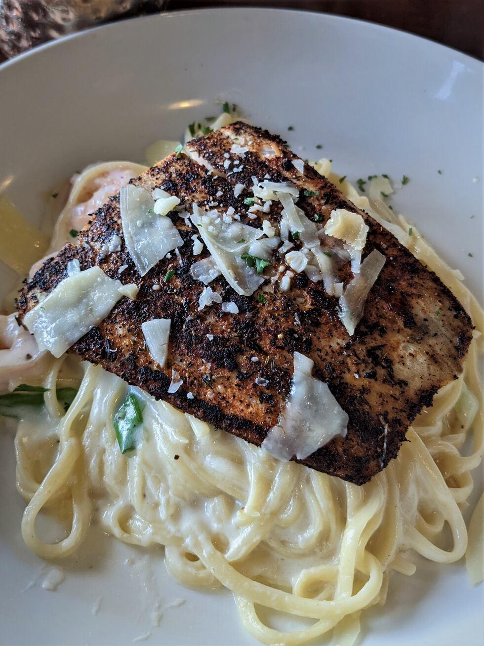 A heaping mound of homemade parmesan alfredo creates the perfect foundation for a blackened...
