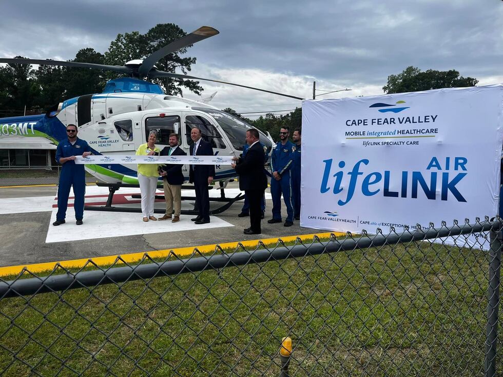 Cape Fear Valley Health officials and Bladen County EMS members take part in a ribbon cutting...