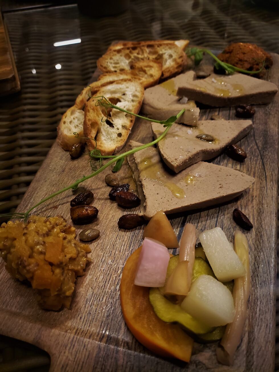 Rich, decadent and airy pate is accompanied by tapenade, mostarda, and crostinis.