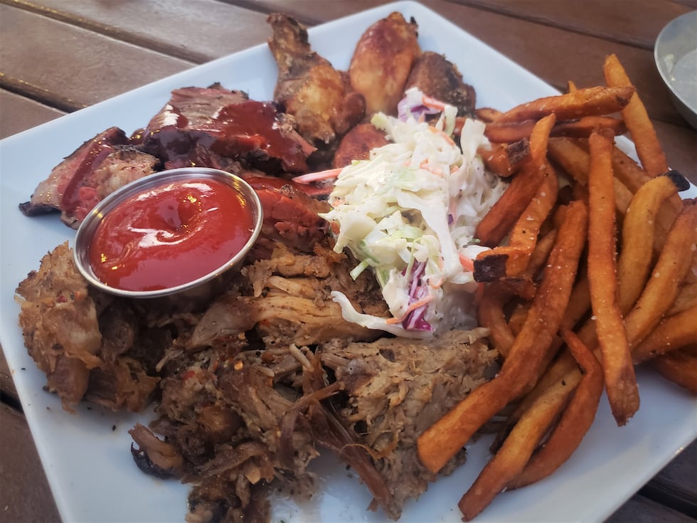 A mix of smoked brisket, pulled pork, and chicken wings with cole slaw and handcut fries.