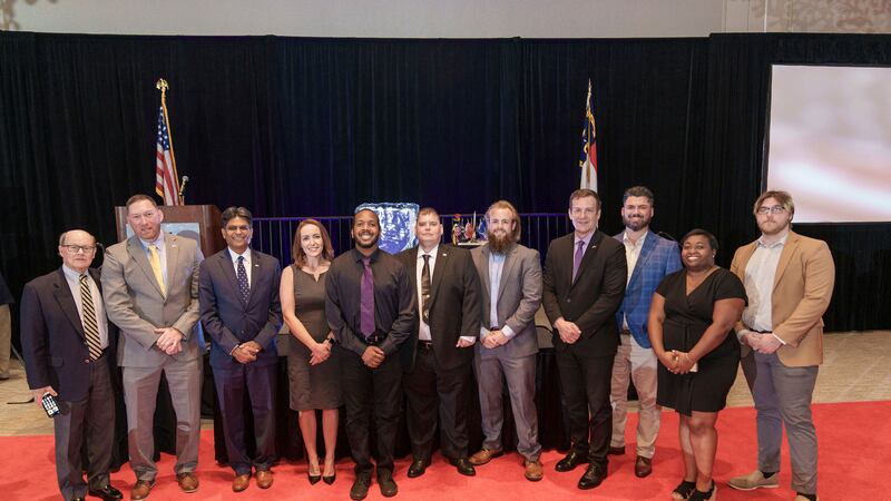 Members of the UNCW Student Veterans Organization celebrate with alumni and dignitaries at the...