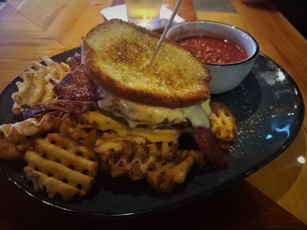 A grilled cheese made for an adult, with waffle fries and tasty marinara dipping sauce.