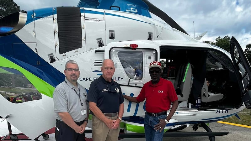 Cape Fear Valley Health officials and Bladen County EMS members take part in a ribbon cutting...
