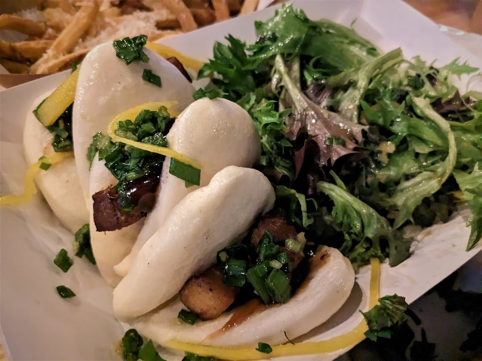 Light, fluffy steamed buns help support crispy pork belly, with pickled daikon, with ginger...