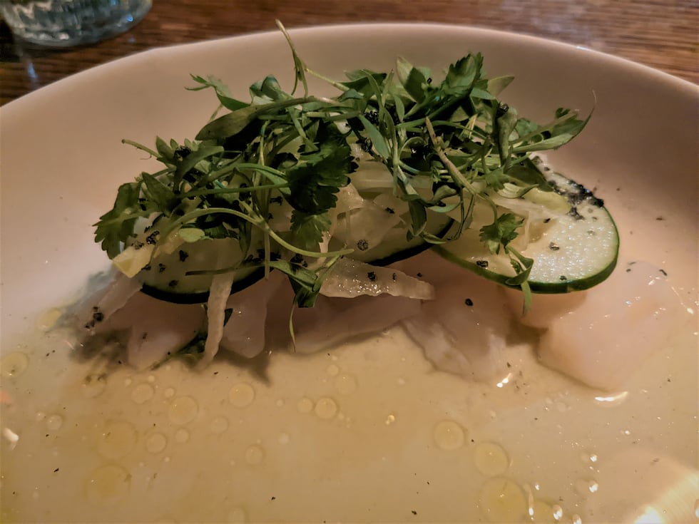 Similar to a ceviche, this aguachile boasts an island of raw scallops, piled high with...