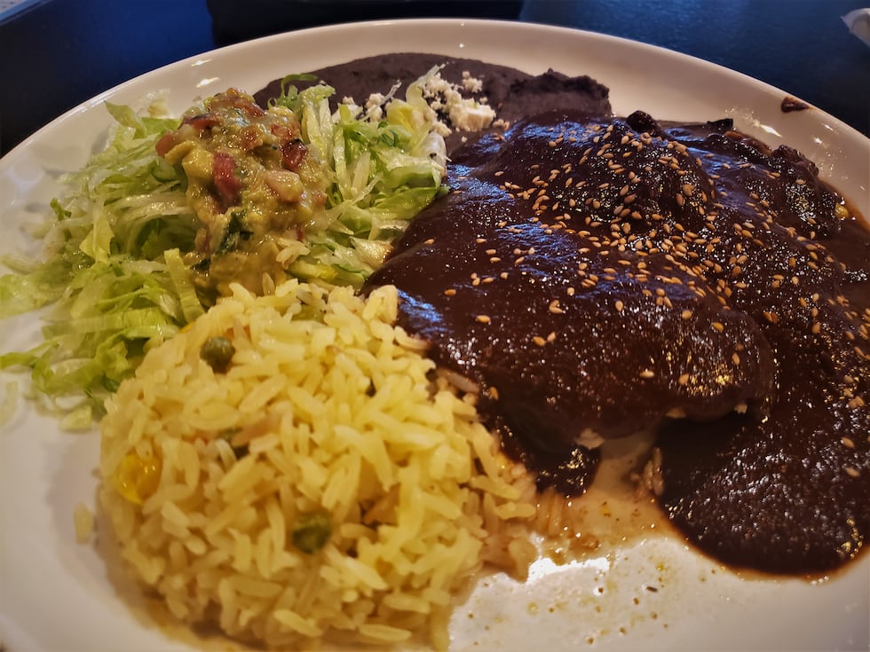Chicken thigh and slow cooked mole sauce from Puebla, Mexico. Served with rice, refried beans,...