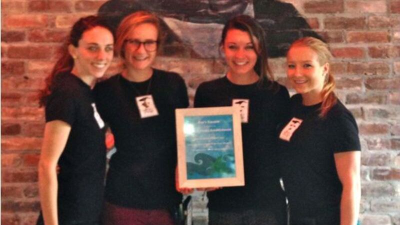 Poe's Tavern employees stand with their ocean friendly establishment plaque. (Source: Plastic...