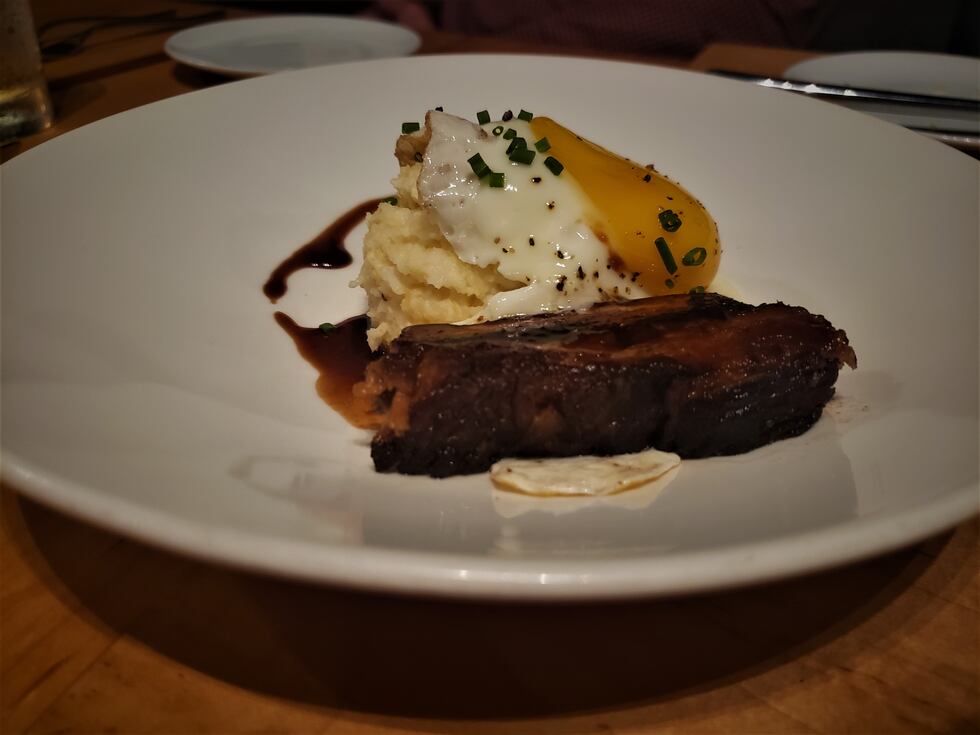 Is it brunch or dinner? No matter, this plate of cheesy polenta, sunny-side up egg and pork...