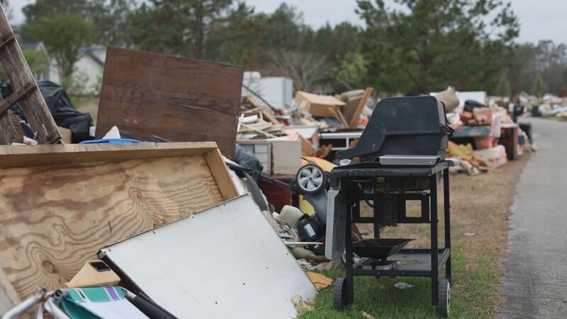 Trash and debris line the roads in the Cross Creek Community of Pender County, one of the...