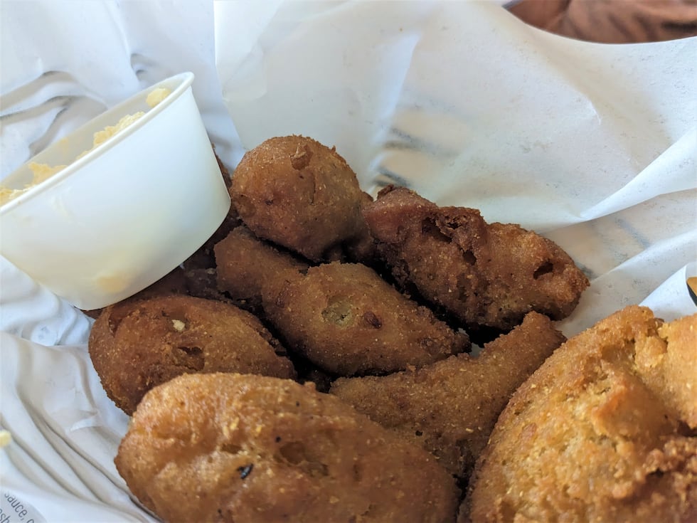 The Oceanic serves up fresh batches of hushpuppies to customers, fried golden brown with a...